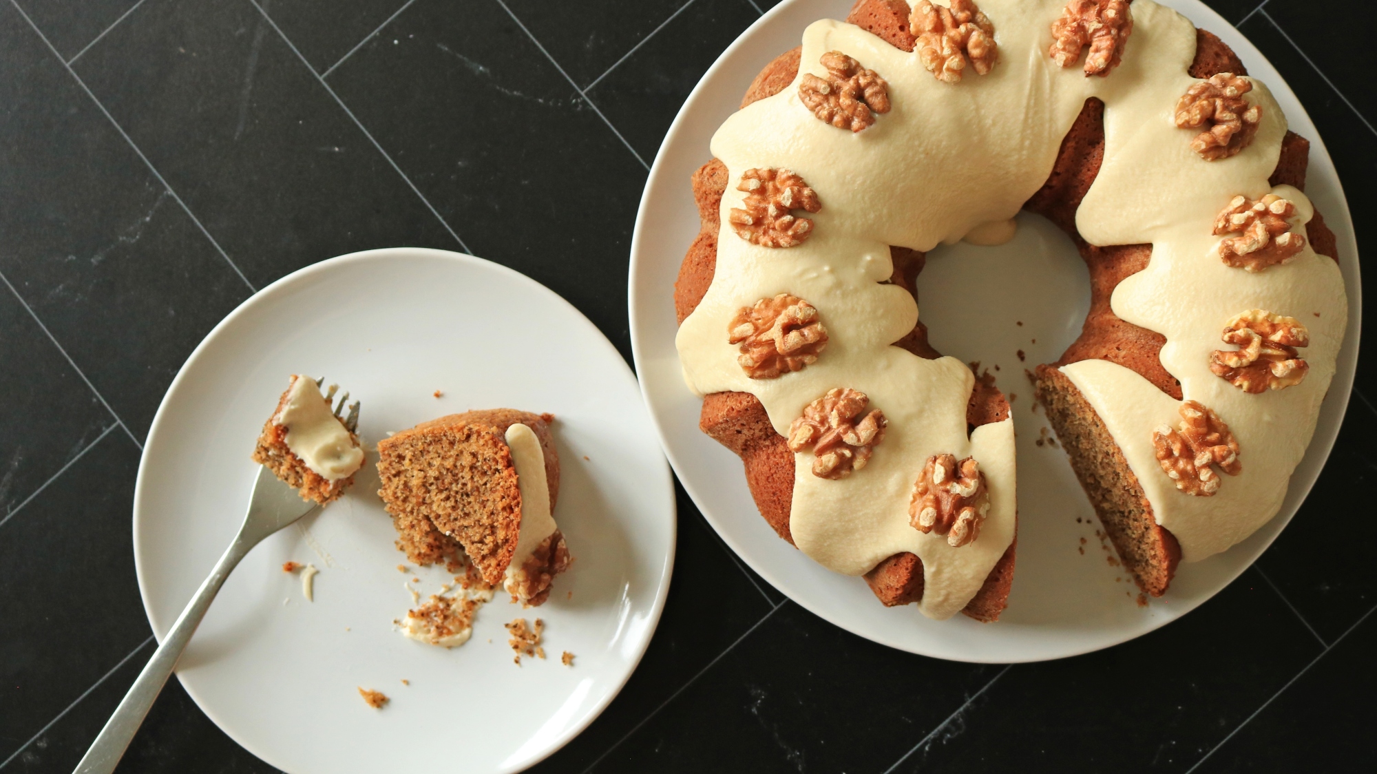 Picture of a bundt cake with walnuts on top.