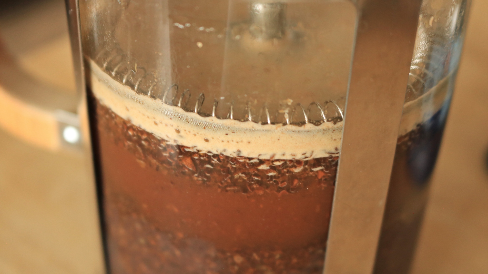 Coffee brewing in a French press.