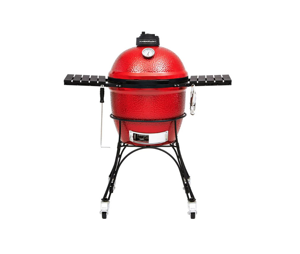 A red kamado grill on a white background.